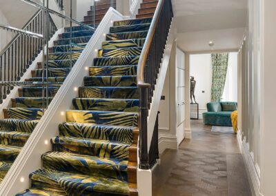 Smart lighting on the staircase at Cadogan Place, London, with LED step lighting, mirrored walls and luxury interior design